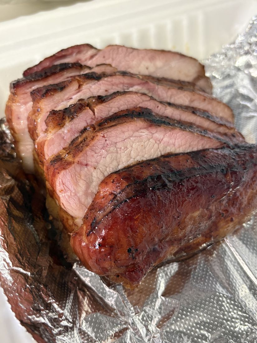 Sliced smoked pork with a dark bark